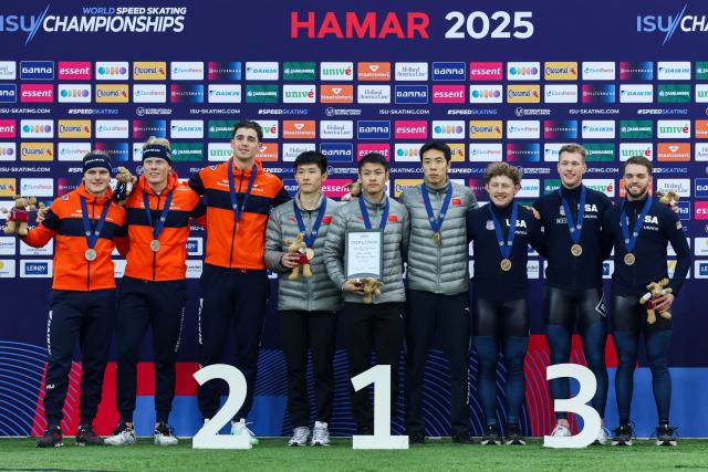 Winners China's Zhiwen Xue, Ziwen Lian and Zhongyan Ning (C), second placed The Netherlands' Janno Botman, Jenning De Boo and Tim Prins (L), and third placed USA's Austin Kleba, Cooper McLeod and Zach Stoppelmoor celebrate on the podium after the men's team sprint race of the ISU World Speed Skating Championships in Hamar, Norway on March 13, 2025. (Photo by Geir Olsen / NTB / AFP) / Norway OUT