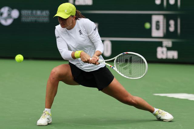 Poland’s Iga Swiatek returns the ball to China’s Qinwen Zheng during the women’s singles quarter-final tennis match at the BNP Paribas Open at the Indian Wells Tennis Garden in Indian Wells, California, on March 13, 2025. (Photo by Patrick T. Fallon / AFP)