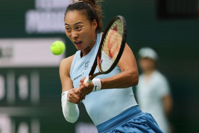 China’s Qinwen Zheng returns the ball to Poland’s Iga Swiatek during the women’s singles quarter-final tennis match at the BNP Paribas Open at the Indian Wells Tennis Garden in Indian Wells, California, on March 13, 2025. (Photo by Patrick T. Fallon / AFP)