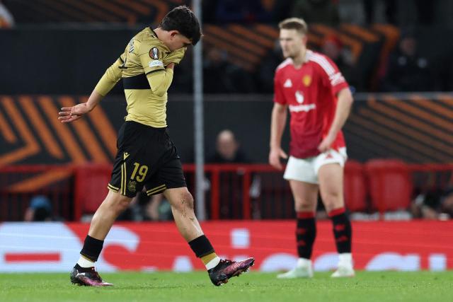 Real Sociedad's Venezuelan defender #19 Jon Aramburu (L) leaves the pitch after receiving a red card during the UEFA Europa League Last 16 Second Leg football match between Manchester United and Real Sociedad at Old Trafford stadium in Manchester, north west England, on March 13, 2025. (Photo by Darren Staples / AFP)