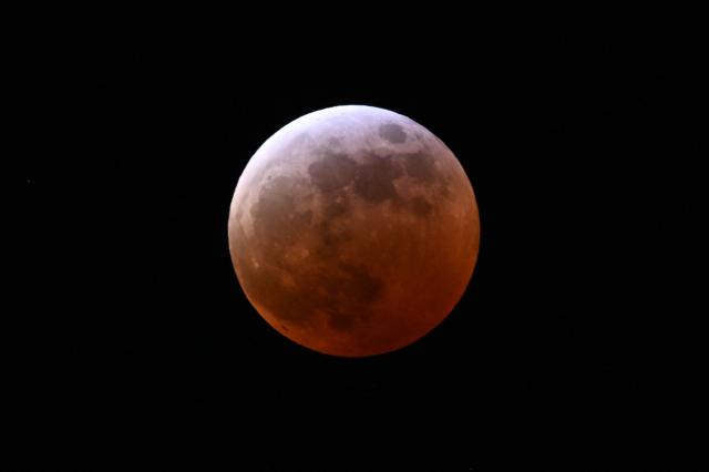 A full lunar eclipse is seen during the Blood Moon Lunar Eclipse in Palm Springs, California, on March 13, 2025. (Photo by Patrick T. Fallon / AFP)