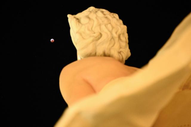 A partial lunar eclipse is seen above the "Forever Marilyn" statue during the Blood Moon Lunar Eclipse in Palm Springs, California, on March 13, 2025. (Photo by Patrick T. Fallon / AFP)