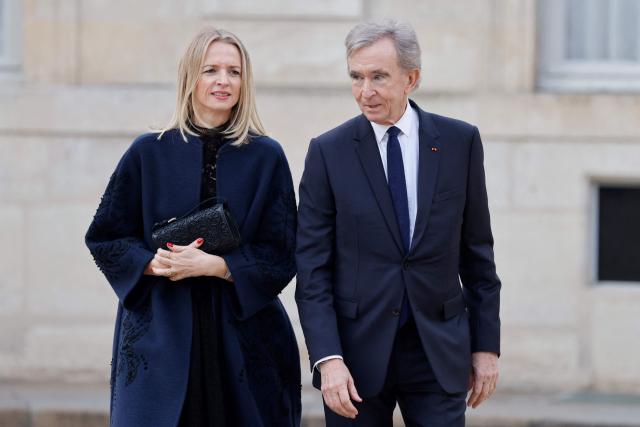 (FILES) Dior CEO Delphine Arnault (L) and her father LVMH CEO Bernard Arnault arrive to attend an official state dinner as part of the Chinese president's two-day state visit to France, at the Elysee Palace in Paris, on May 6, 2024. LVMH will propose at its annual general meeting to raise the CEO retirement age from 80 to 85, allowing Bernard Arnault, 76, to remain at the helm of the world's leading luxury goods company for longer. (Photo by Ludovic MARIN / AFP)