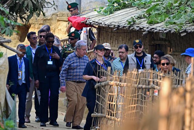 United Nations Secretary-General António Guterres (center L) visits a Rohingya refugee camp in Ukhia, Cox' Bazar on March 14, 2025. Guterres said on March 14 the organisation would do "everything" to prevent food rations being cut for Rohingya refugees in Bangladesh. (Photo by Munir UZ ZAMAN / AFP)