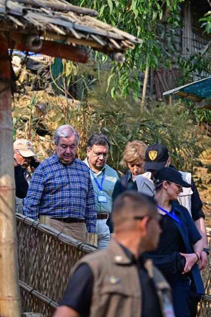 United Nations Secretary-General António Guterres (center L) visits a Rohingya refugee camp in Ukhia, Cox' Bazar on March 14, 2025. Guterres said on March 14 the organisation would do "everything" to prevent food rations being cut for Rohingya refugees in Bangladesh. (Photo by Munir UZ ZAMAN / AFP)