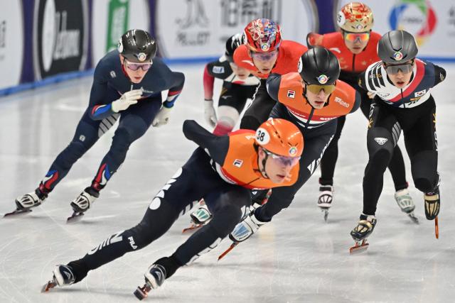 Netherland’s Jens Van ‘T Wout (13) and Daan Kos (38) compete in the men’s 1500 meter semifinals at the 2025 ISU World Short Track Championships in Beijing on March 15, 2025. (Photo by ADEK BERRY / AFP)