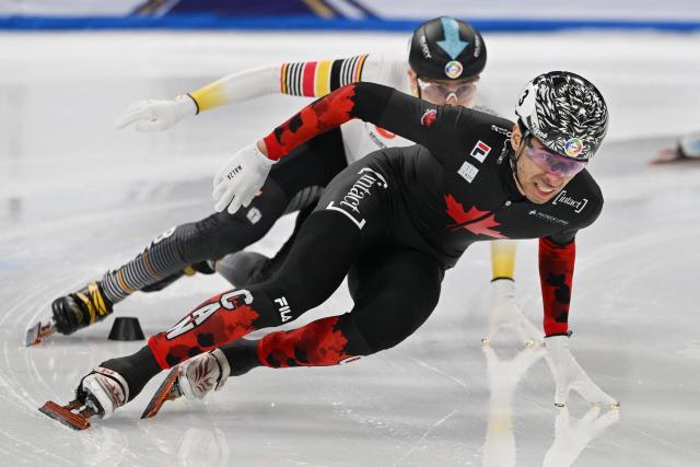 Canada’s William Dandjinou (front) leads Belgium’s Stijn Desmet in the men’s 1500 meter final at the ISU World Short Track Championships in Beijing on March 15, 2025. (Photo by GREG BAKER / AFP)