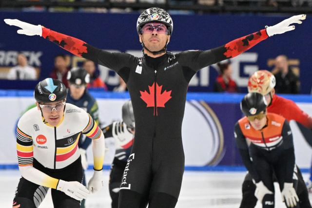 Canada’s William Dandjinou (C) celebrates after winning the men’s 1500 meter final at the ISU World Short Track Championships in Beijing on March 15, 2025. (Photo by ADEK BERRY / AFP)