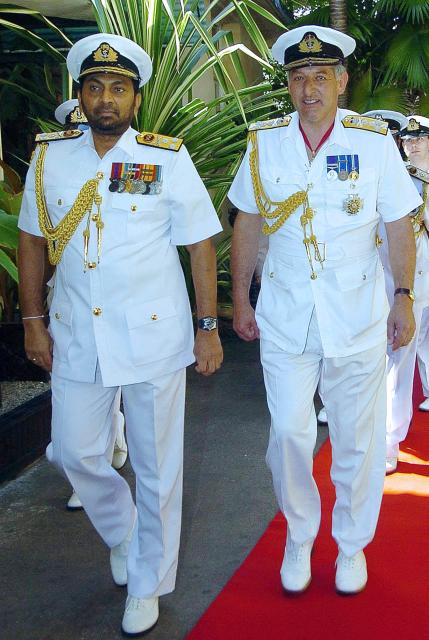 (FILES) Sri Lankan Navy Commander Wasantha Karannagoda (L) and visiting British Royal Navy Admiral and fleet Commander-in-chief Jonathon Band (R) arrive at the Sri Lanka Navy Headquarters in Colombo on June 2 2006. The UK on Monday, March 24, announced sanctions against four senior combatants in the Sri Lanka civil war that ended in 2009, who it said were "responsible for serious human rights violations and abuses" during the decades-long conflict. The sanctioned individuals include former navy commander Wasantha Karannagoda. (Photo by LAKRUWAN WANNIARACHCHI / AFP)