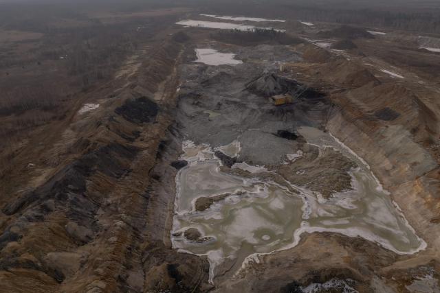(FILES) An aerial view shows a dragline excavator operating in an open-pit titanium mine in the Zhytomyr region, on February 28, 2025, amid the Russian invasion of Ukraine. The United States and Ukraine on April 30, 2025 signed a minerals deal after a two-month delay, in what President Donald Trump's administration called a new form of US commitment to Kyiv after the end of military aid. Ukraine said it secured key interests after protracted negotiations, including full sovereignty over its own rare earths, which are vital for new technologies and largely untapped. (Photo by Roman PILIPEY / AFP)