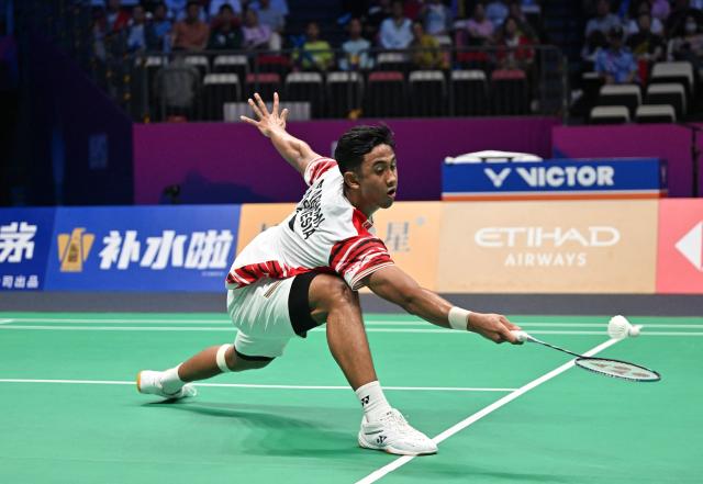 Indonesia’s Alwi Farhan hits a return to Denmark’s Anders Antonsen during their men’s singles match at the Sudirman Cup badminton championship in Xiamen, China’s southeastern province on May 1, 2025. (Photo by ADEK BERRY / AFP)