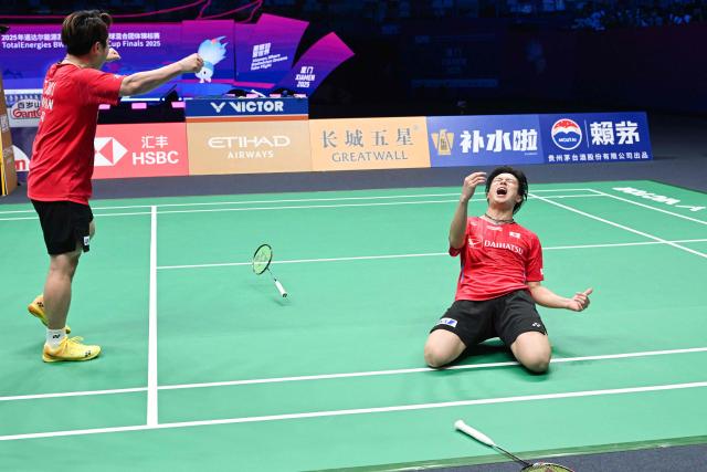 Japan's Takuro Hoki (L) and Yugo Kobayashi celebrate defeating Malaysia’s Aaron Chia and Soh Wooi Yik in their men’s doubles match at the Sudirman Cup badminton championship in Xiamen, China’s southeastern province on May 1, 2025. (Photo by ADEK BERRY / AFP)