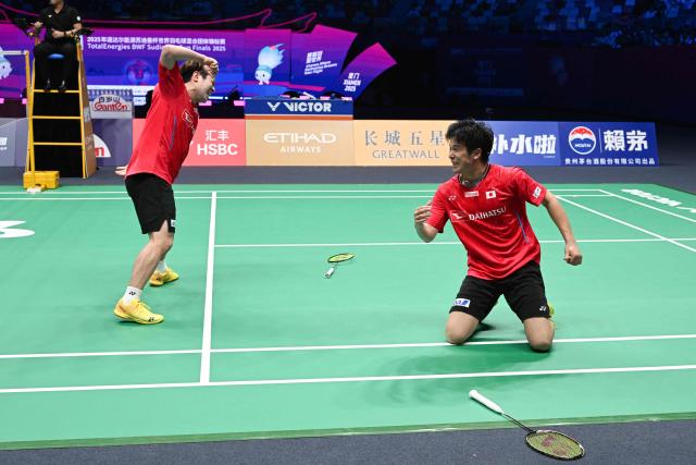 Japan's Takuro Hoki (L) and Yugo Kobayashi celebrate defeating Malaysia’s Aaron Chia and Soh Wooi Yik in their men’s doubles match at the Sudirman Cup badminton championship in Xiamen, China’s southeastern province on May 1, 2025. (Photo by ADEK BERRY / AFP)