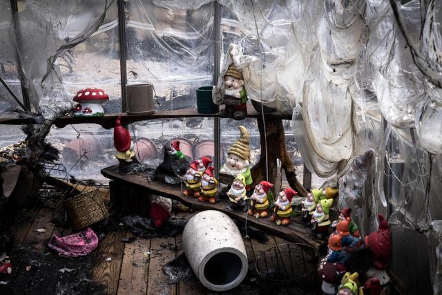 Garden gnomes are pictured in a burnt garden shop in Mesilat Zion in central Israel, on May 1, 2025. Israeli firefighting teams battled wildfires near Jerusalem for a second day on May 1, with police reporting the reopening of several major roads that had been closed. (Photo by JOHN WESSELS / AFP)
