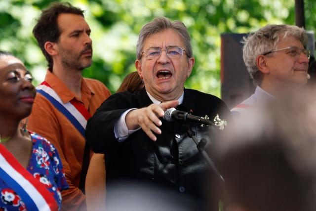 Founder of French left-wing La France Insoumise (LFI) party Jean-Luc Melenchon, flanked by La France Insoumise - Nouveau Front Populaire's MP Eric Coquerel (R), La France Insoumise - Nouveau Front Populaire's MP Daniele Obono (L) and La France Insoumise - Nouveau Front Populaire's MP Bastien Lachaud (2nd L), delivers a speech during a May Day (Labour Day) rally, marking International Workers' Day, in Paris, on May 1, 2025. (Photo by Ian LANGSDON / AFP)
