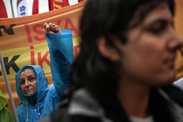 A protester raises her fist during a May Day (Labour Day) rally, marking International Workers' Day, in the Kadikoy district of Istanbul, on May 1, 2025. Turkish police on May 1, 2024, detained dozens of protesters attempting to tear down barricades in different districts of Istanbul after authorities banned May 1 rallies at the city's main Taksim Square. (Photo by Ozan KOSE / AFP)