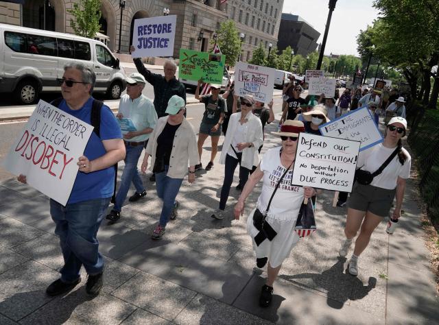 Protesters near the White House during a Free Kilmar Abrego Garcia Now march rally in Washington, DC on May 1, 2025. Abrego Garcia was detained in Maryland in February 2025 and expelled to El Salvador along with 238 Venezuelans and 22 fellow Salvadorans who were deported shortly after President Donald Trump invoked a rarely-used wartime authority. (Photo by Oliver Contreras / AFP)