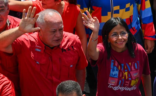 Venezuela's Interior Minister Diosdado Cabello (L) and Vice President Delcy Rodriguez take part in a Labour Day march in Caracas on May 1, 2025. Venezuelan President Nicolas Maduro has increased pensions from $1.50 to $50 and welfare bonuses ahead of a controversial regional vote as the country fights chronic inflation -- but kept the $1.50 minimum monthly wage unchanged. (Photo by Juan BARRETO / AFP)