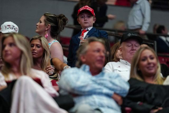 A boy in a suit and MAGA hat is seen inside Coleman Coliseum before US President Donald Trump delivers commencement remarks at the University of Alabama in Tuscaloosa, Alabama, on May 1, 2025. (Photo by Elijah Nouvelage / AFP)