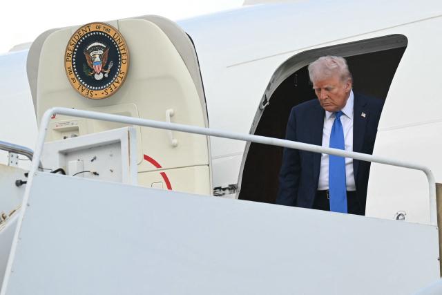 US President Donald Trump steps off of Air Force One upon arrival at Tuscaloosa National Airport in Tuscaloosa, Alabama, on May 1, 2025. Trump is headed to the University of Alabama to deliver remarks at a commencement. (Photo by SAUL LOEB / AFP)