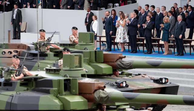 (FILES) (Bottom row, from R) French President and Senate President Gerard Larcher, wife of French President Brigitte Macron, French President Emmanuel Macron, US President Donald Trump, US First Lady Melania Trump, French Prime Minister Edouard Philippe and French Defence Minister Florence Parly look at members of the 5e Regiment de Cuirassiers ride by in tanks as they attend the annual Bastille Day military parade on the Champs-Elysees avenue in Paris on July 14, 2017. The United States will stage a military parade on June 14, 2025, to mark the 250th anniversary of the founding of the US Army, the White House said on May 2, 2025, with the event also falling on President Donald Trump's 79th birthday. (Photo by joel SAGET / AFP)