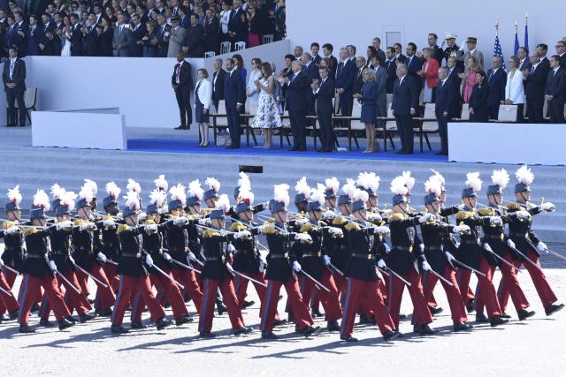 (FILES) (FromL) French Defence Minister Florence Parly, French Prime Minister Edouard Philippe, US President Donald Trump and US First Lady Melania Trump, French President Emmanuel Macron and his wife Brigitte Macron, Senate President Gerard Larcher (2ndR), the President of the French National Assembly Francois de Rugy and the Mayor of Paris Anne Hidalgo look at members of the Ecole speciale militaire de Saint-Cyr (Special Military School of Saint-Cyr) marching during the annual Bastille Day military parade on the Champs-Elysees avenue in Paris on July 14, 2017. The United States will stage a military parade on June 14, 2025, to mark the 250th anniversary of the founding of the US Army, the White House said on May 2, 2025, with the event also falling on President Donald Trump's 79th birthday. (Photo by SAUL LOEB / AFP)
