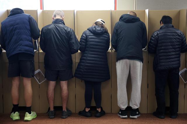 Voters cast their ballots in Australia’s general election at a polling station in Melbourne on May 3, 2025. (Photo by Martin KEEP / AFP)