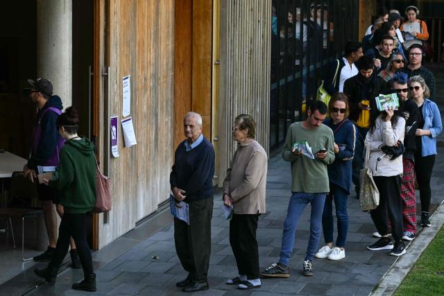People queue to vote in Australia's general election at a polling station in the suburb of Marrickville in Sydney on May 3, 2025. Australians began voting on May 3 in a bitterly contested general election, deciding a contest shaped by living costs, climate anxiety and US President Donald Trump's tariffs. (Photo by Saeed KHAN / AFP)