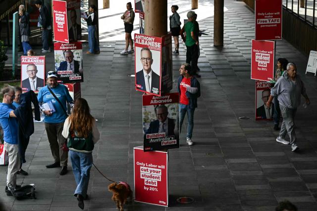 Posters of Australia's Prime Minister Anthony Albanese for the general election are displayed outside a polling centre in the suburb of Marrickville in Sydney on May 3, 2025. Australians began voting on May 3 in a bitterly contested general election, deciding a contest shaped by living costs, climate anxiety and US President Donald Trump's tariffs. (Photo by Saeed KHAN / AFP)