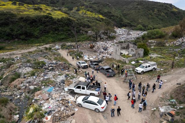 This aerial view shows members of the collective for the search of missing persons and authorities preparing to take part in a search at the Las Carretas Canyon area in Tijuana, Baja California state, Mexico on May 2, 2025. (Photo by Guillermo Arias / AFP)