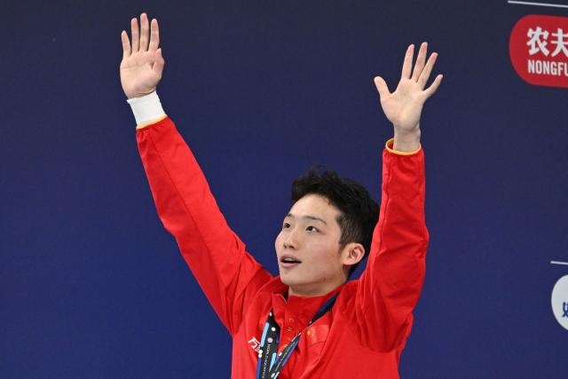 China’s Wang Zongyuan celebrates on the podium after winning the men’s 3 meter springboard event at the World Aquatics Diving World Cup Super Final, in the Water Cube in Beijing on May 3, 2025. (Photo by GREG BAKER / AFP)