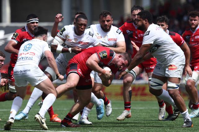 Lyon's French hooker Guillaume Marchand (C) is challenged by Racing92's French flancker Cameron Woki (C, L) during the European Rugby Challenge Cup semi-final rugby union match between Lyon Olympique Universitaire Rugby (LOU) and Racing 92 at the Gerland stadium in Lyon, central-eastern France on May 4, 2025. (Photo by Alex MARTIN / AFP)