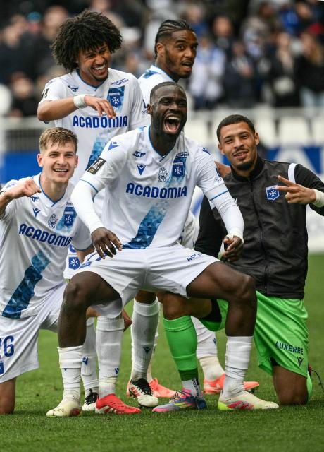 Auxerre’s Malian forward #17 Lassine Sinayoko (2nd R) celebrates with his teamates after scoring his team's opening goal during the French L1 football match between AJ Auxerre and Le Havre AC at Stade de l'Abbe-Deschamps in Auxerre, central France on May 4, 2025. (Photo by ARNAUD FINISTRE / AFP)