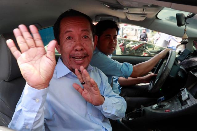 Rong Chhun (L), an advisor of the Nation Power Party, gestures from a car near the Phnom Penh municipal court on May 5, 2025. A Cambodian court sentenced an outspoken opposition politician to four years in jail for incitement on May 5, he told reporters, barring him from voting and holding office. (Photo by AFP)