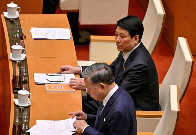 Vietnam's President Luong Cuong (R) and Vietnam's General Secretary of the Communist Party To Lam (L) attend the National Assembly's summer session opening in Hanoi on May 5, 2025. (Photo by Nhac NGUYEN / AFP)
