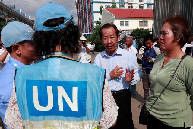 Rong Chhun (2nd R), an advisor of the Nation Power Party, speaks to UN officials near the Phnom Penh municipal court on May 5, 2025. A Cambodian court sentenced an outspoken opposition politician to four years in jail for incitement on May 5, he told reporters, barring him from voting and holding office. (Photo by AFP)