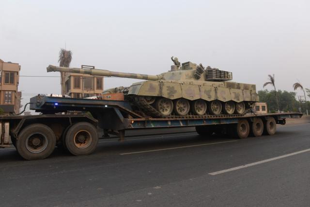 A truck transports an army tank on a road in Muridke, about 30 kilometres from Lahore, on May 7, 2025. India fired missiles at Pakistani territory early on May 7, killing at least eight people, according to Pakistan, which said it had begun retaliating in a major escalation between the nuclear-armed rivals. (Photo by Murtaz Ali / AFP)