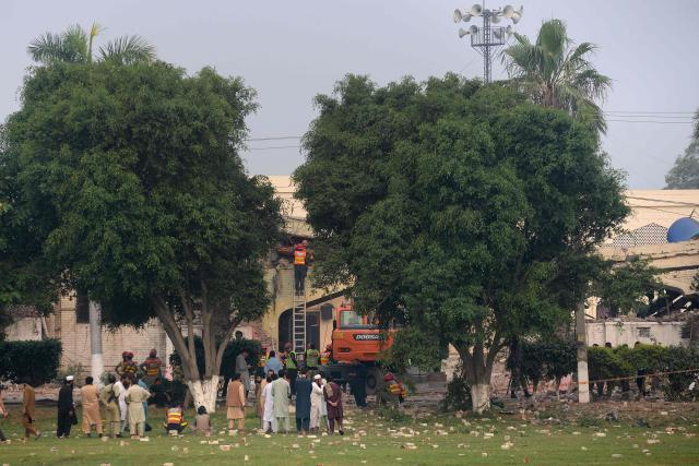 Rescuers search for victims in the debris of a damaged building of the Government Health and Educational complex after Indian strikes in Muridke, about 30 kilometres from Lahore, on May 7, 2025. India fired missiles at Pakistani territory early on May 7, killing at least eight people, according to Pakistan, which said it had begun retaliating in a major escalation between the nuclear-armed rivals. (Photo by Murtaz Ali / AFP)
