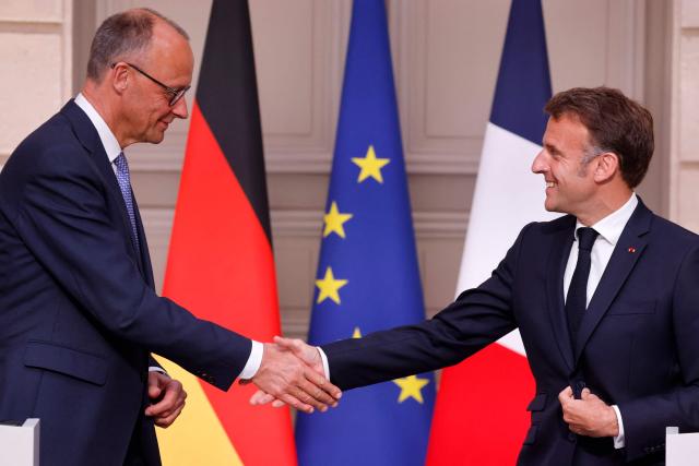 Germany's newly elected Chancellor Friedrich Merz (L) and France's President Emmanuel Macron (R) shake hands at the end of a joint press conference following their meeting at the Elysee presidential palace in Paris on May 7, 2025. Merz visits France and Poland on May 7, on a mission to boost ties with the European neighbours in turbulent times. (Photo by Ludovic MARIN / AFP)