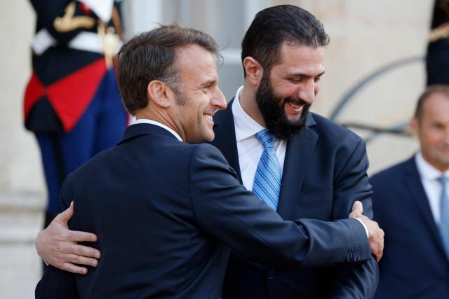 TOPSHOT - French President Emmanuel Macron (L) and Syrian President Ahmed al-Sharaa greet each other after a joint press conference following a meeting at the Elysee Palace in Paris, on May 7, 2025. Syrian interim President Ahmed al-Sharaa arrived in Paris on May 7, state media reported, on his first visit to Europe since overthrowing longtime ruler Bashar al-Assad in December. (Photo by Ludovic MARIN / AFP)