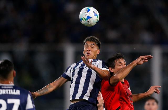 Talleres' midfielder #05 Alejandro Galarza and Libertad's forward #24 Roque Santa Cruz fight for the ball during the Copa Libertadores group stage first round football match between Argentina's Talleres de Cordoba and Paraguay's Libertad at the Mario Alberto Kempes stadium in Cordoba, Argentina, on May 8, 2025. (Photo by Diego Lima / AFP)