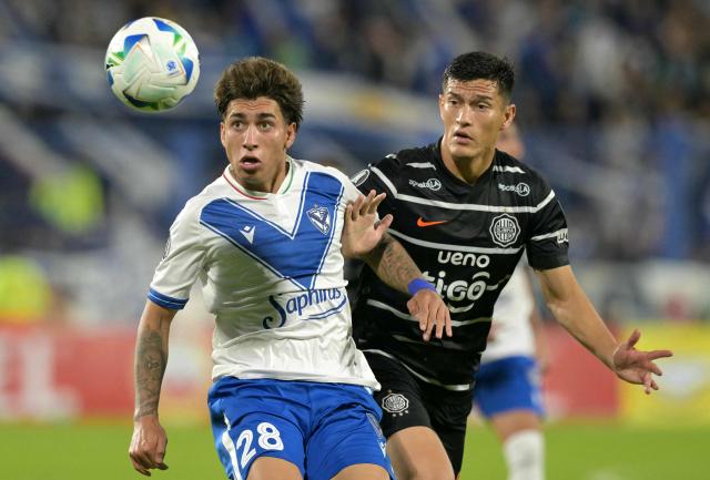 Velez Sarsfield's forward #28 Maher Carrizo and Olimpia's defender #15 Axel Alfonzo fight for the ball during the Copa Libertadores group stage first round football match between Argentina's Velez Sarsfield and Paraguay's Olimpia at the Jose Amalfitani stadium in Buenos Aires on May 8, 2025. (Photo by JUAN MABROMATA / AFP)