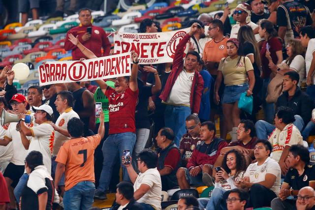 Fans of Universitario cheer for their team during the Copa Libertadores group stage first round football match between Peru's Universitario de Lima and Ecuador's Independiente del Valle at the Monumental "U" Marathon stadium in Lima, on May 8, 2025. (Photo by STRINGER / AFP)