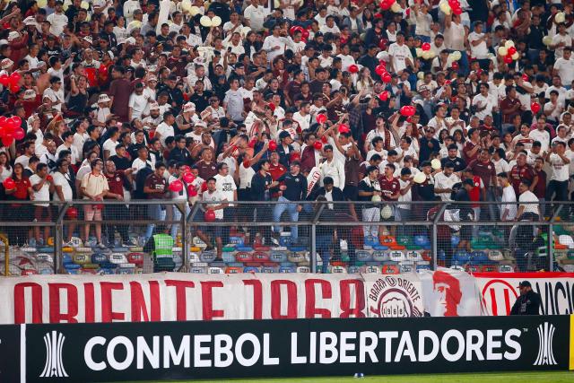 Fans of Universitario cheer for their team during the Copa Libertadores group stage first round football match between Peru's Universitario de Lima and Ecuador's Independiente del Valle at the Monumental "U" Marathon stadium in Lima, on May 8, 2025. (Photo by STRINGER / AFP)