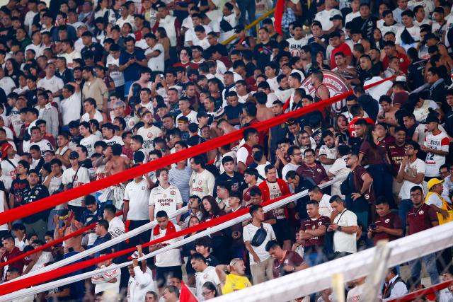 Fans of Universitario cheer for their team during the Copa Libertadores group stage first round football match between Peru's Universitario de Lima and Ecuador's Independiente del Valle at the Monumental "U" Marathon stadium in Lima, on May 8, 2025. (Photo by STRINGER / AFP)