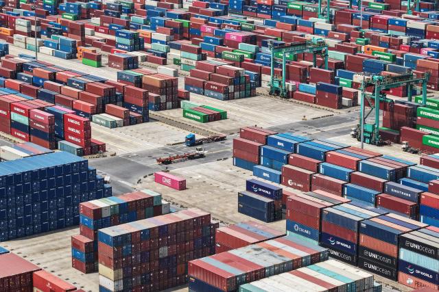 Shipping containers are stacked at a port in Shanghai on May 9, 2025. China said on May 9 sales to the United States slumped last month while its total exports topped forecasts, as Beijing fought a gruelling trade war with its superpower rival. (Photo by AFP) / China OUT