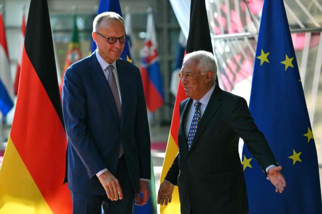 European Council President Antonio Costa (R) and German Chancellor Friedrich Merz (L) arrive prior to a meeting at the European Council headquarters in Brussels on May 9, 2025. (Photo by Nicolas TUCAT / AFP)