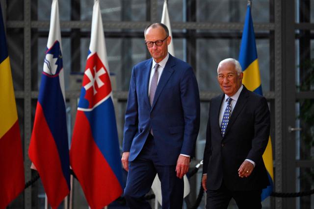 European Council President Antonio Costa (R) and German Chancellor Friedrich Merz (L) arrive prior to a meeting at the European Council headquarters in Brussels on May 9, 2025. (Photo by Nicolas TUCAT / AFP)