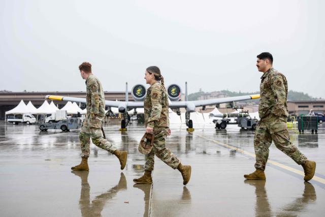 US soldiers walk past a Fairchild Republic A-10 Thunderbolt II plane during a media day for the Osan Air Power Days 2025 at Osan Air Base in Pyeongtaek on May 9, 2025. (Photo by ANTHONY WALLACE / AFP)