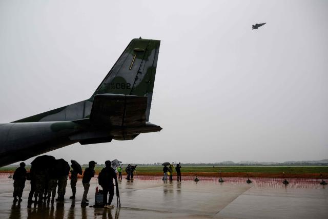 A US F-35B (top R) flies above members of the media during a media day for the Osan Air Power Days 2025 at Osan Air Base in Pyeongtaek on May 9, 2025. (Photo by ANTHONY WALLACE / AFP)